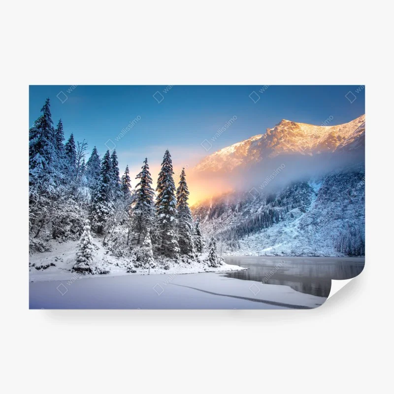Wall mural winter sunrise over snowy mountain lake