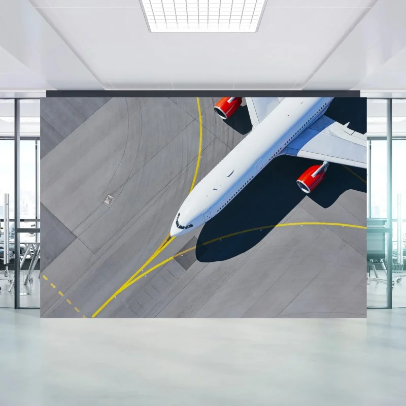 Wall mural aerial view of a white airplane on tarmac