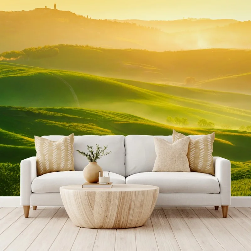 Wall mural golden sunrise over rolling green hills