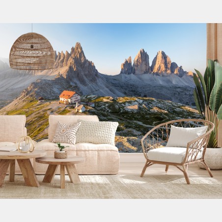 Wall mural sunlit mountain refuge at dawn • Wallissimo®