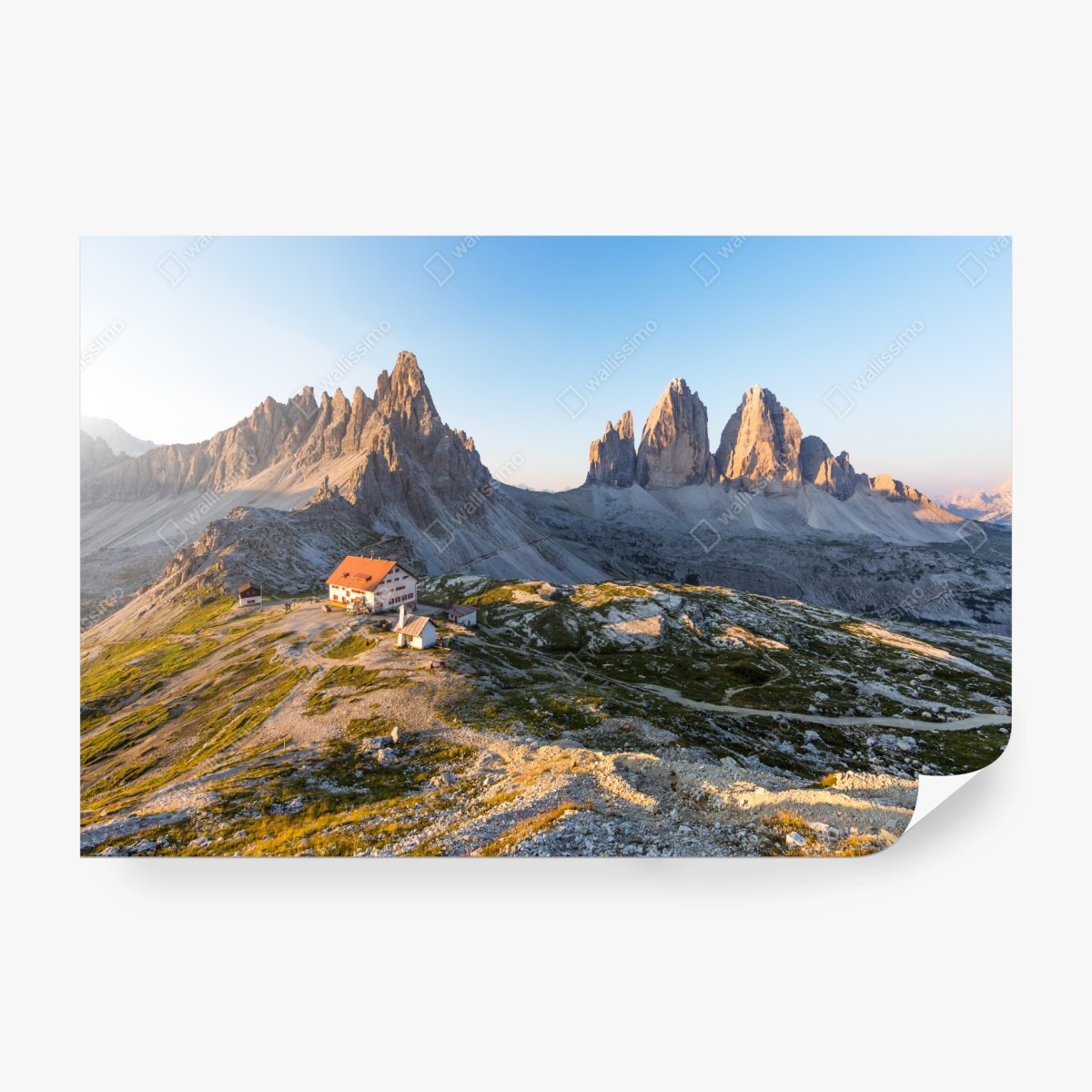 Wall mural sunlit mountain refuge at dawn • Wallissimo®