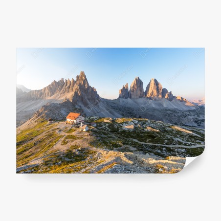 Wall mural sunlit mountain refuge at dawn • Wallissimo®