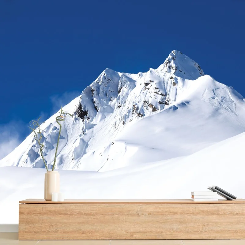 Wall mural snow-covered alpine peak under deep blue sky