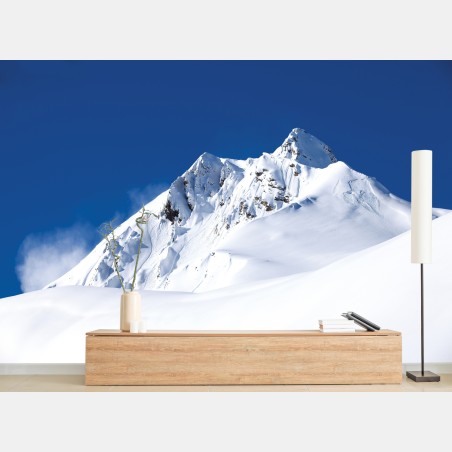 Wall mural snow-covered alpine peak under deep blue sky • Wallissimo®