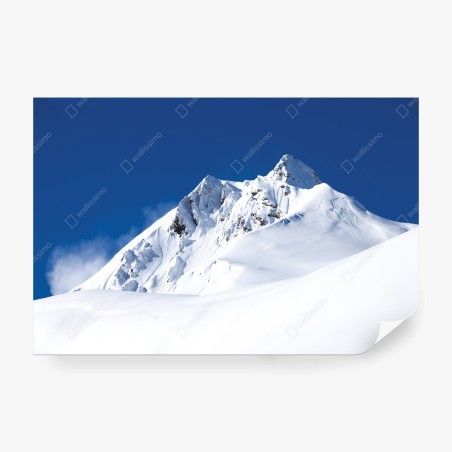 Wall mural snow-covered alpine peak under deep blue sky • Wallissimo®