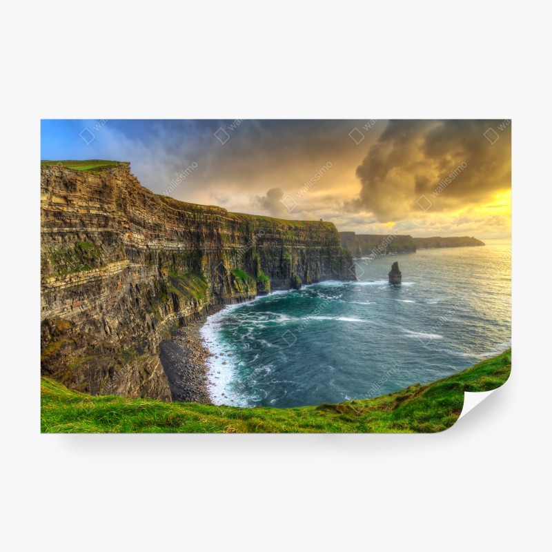 Wall mural dramatic coastal cliffs at sunset