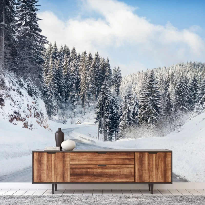 Wall mural winter road through snowy fir forest