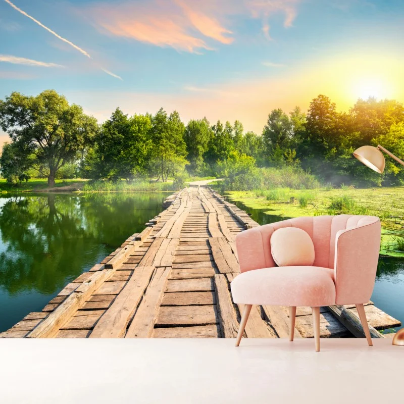 Wall mural sunlit wooden bridge over tranquil lake