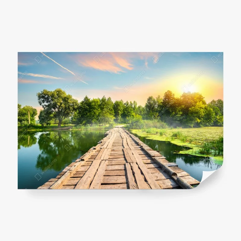 Wall mural sunlit wooden bridge over tranquil lake