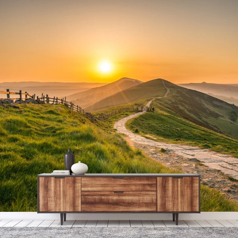 Wall mural sunrise over rolling green hills