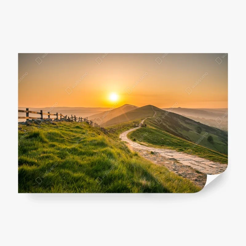 Wall mural sunrise over rolling green hills