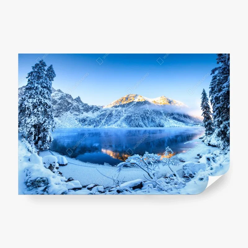 Wall mural winter sunrise over frozen mountain lake