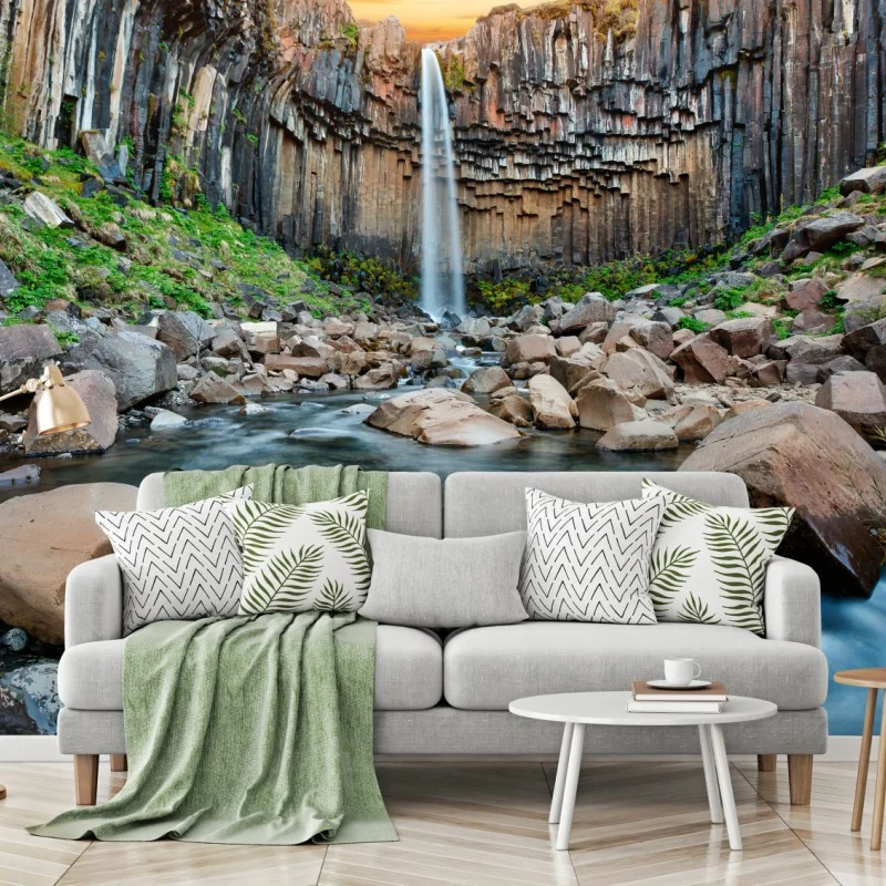 Wall mural dramatic waterfall amid basalt cliffs
