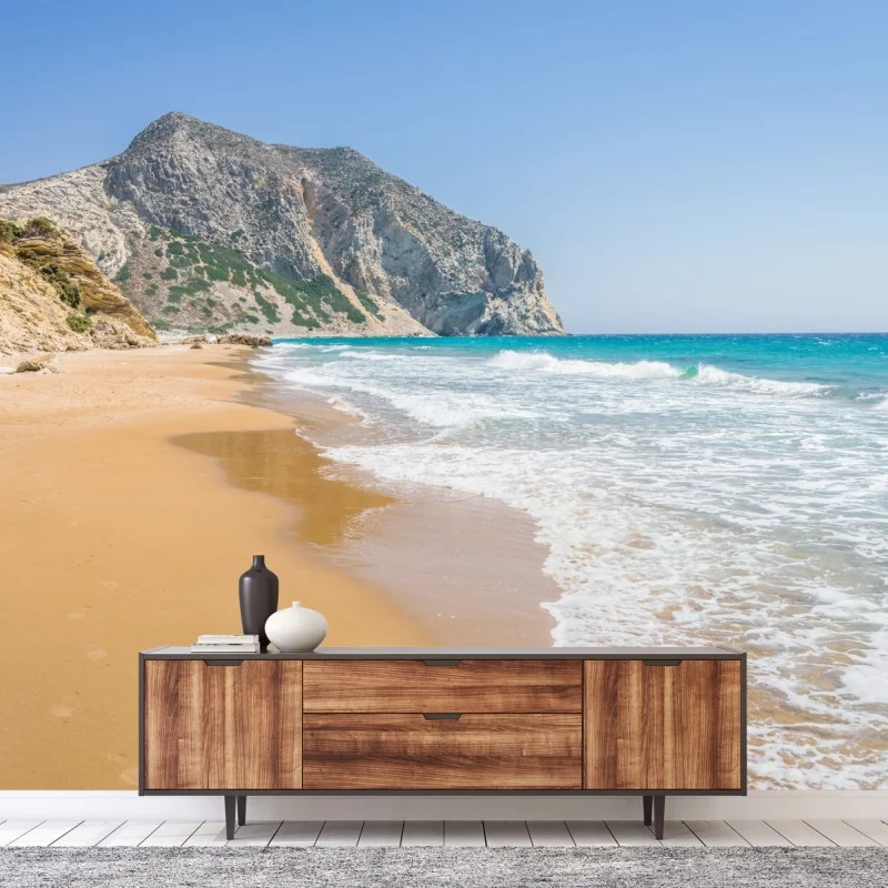 Wall mural sunlit turquoise beach with cliffs