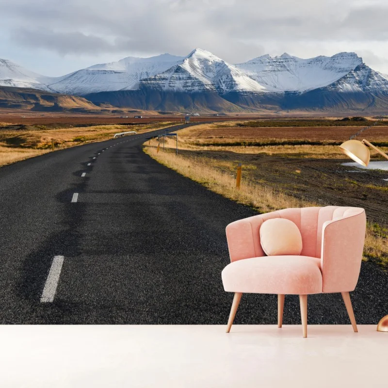Wall mural empty road to snow-capped mountains in Iceland
