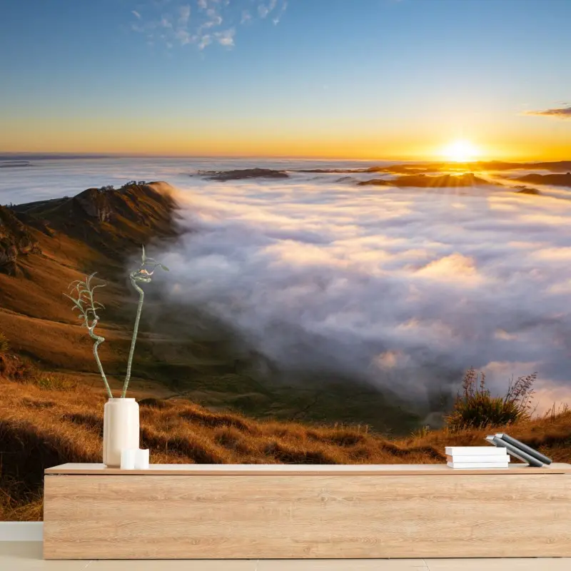 Wall mural sunrise over misty mountain valley