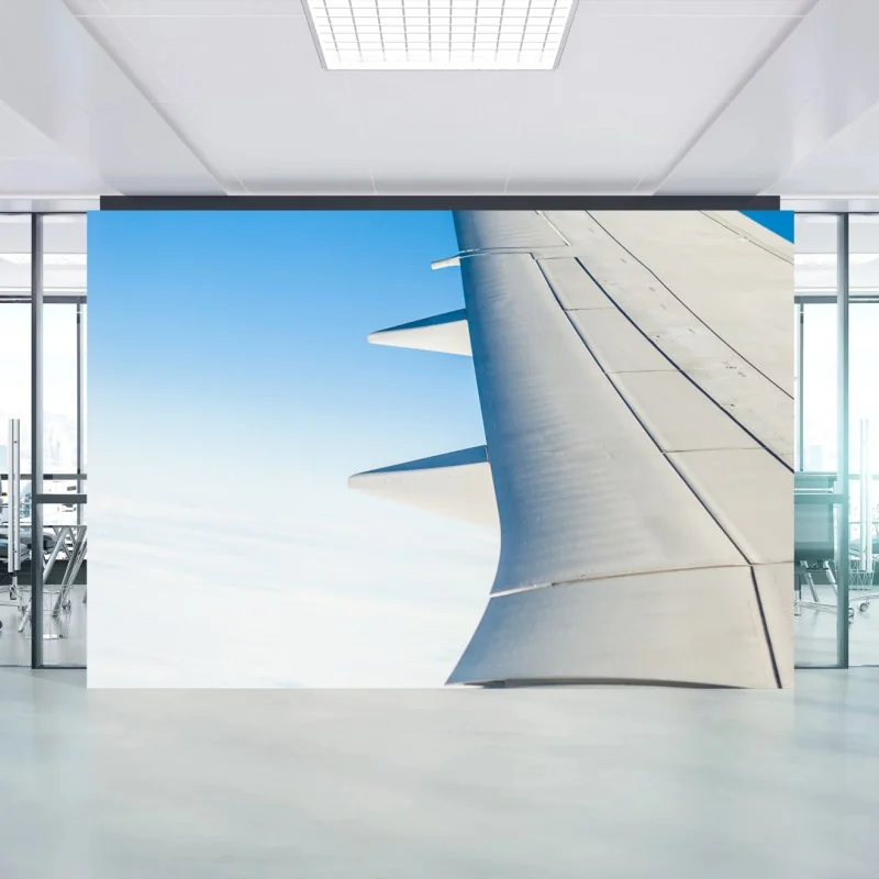 Wall mural wing above clouds in clear blue sky