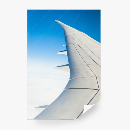 Wall mural wing above clouds in clear blue sky • Wallissimo®
