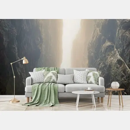 Wall mural sunlit narrow canyon between towering cliffs • Wallissimo®