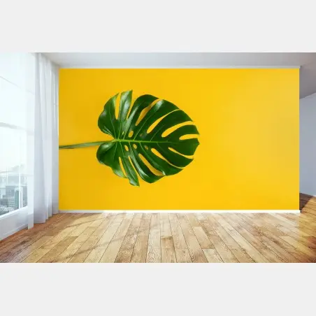 Wall mural monstera leaf on vibrant yellow background • Wallissimo®
