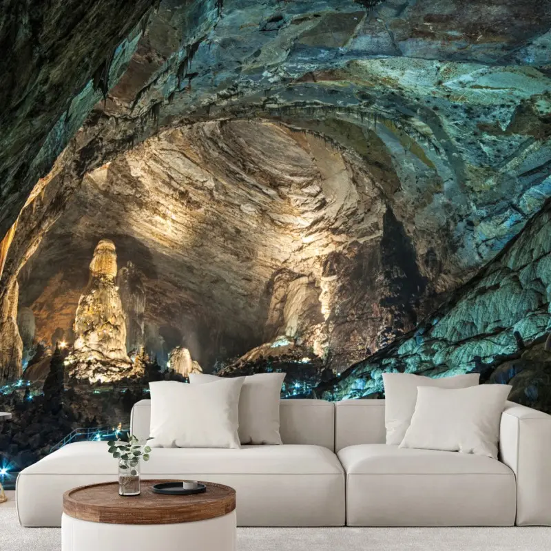 Wall mural illuminated cave interior with towering stalagmites