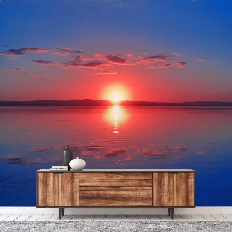 Wall mural sunset over calm sea with vivid reflection
