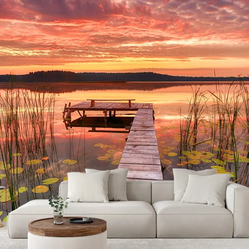 Wall mural sunrise over a tranquil lake pier