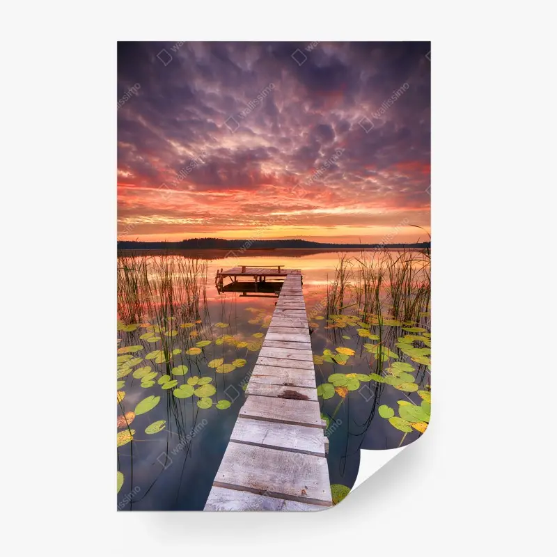 Wall mural sunrise over a tranquil lake pier