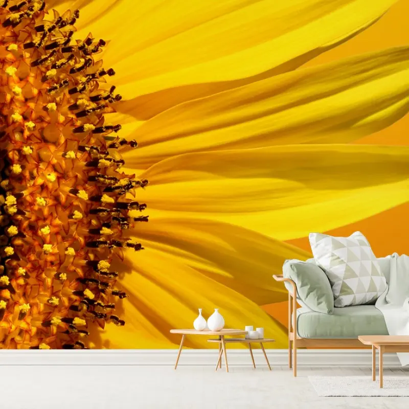 Wall mural bright sunflower close-up on yellow background
