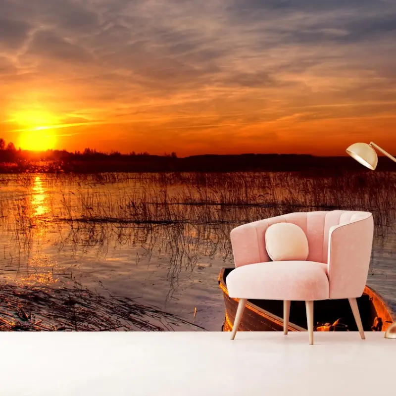 Wall mural sunset boat on a tranquil lake