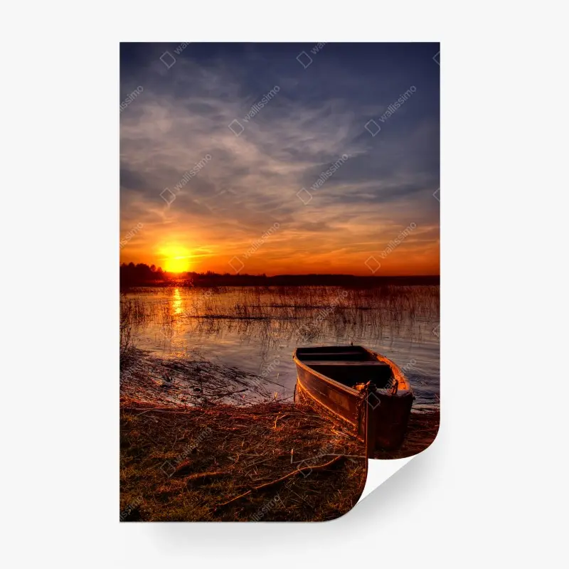 Wall mural sunset boat on a tranquil lake