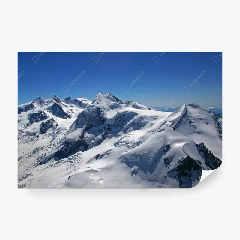 Wall mural snow-covered alpine peaks under clear blue sky
