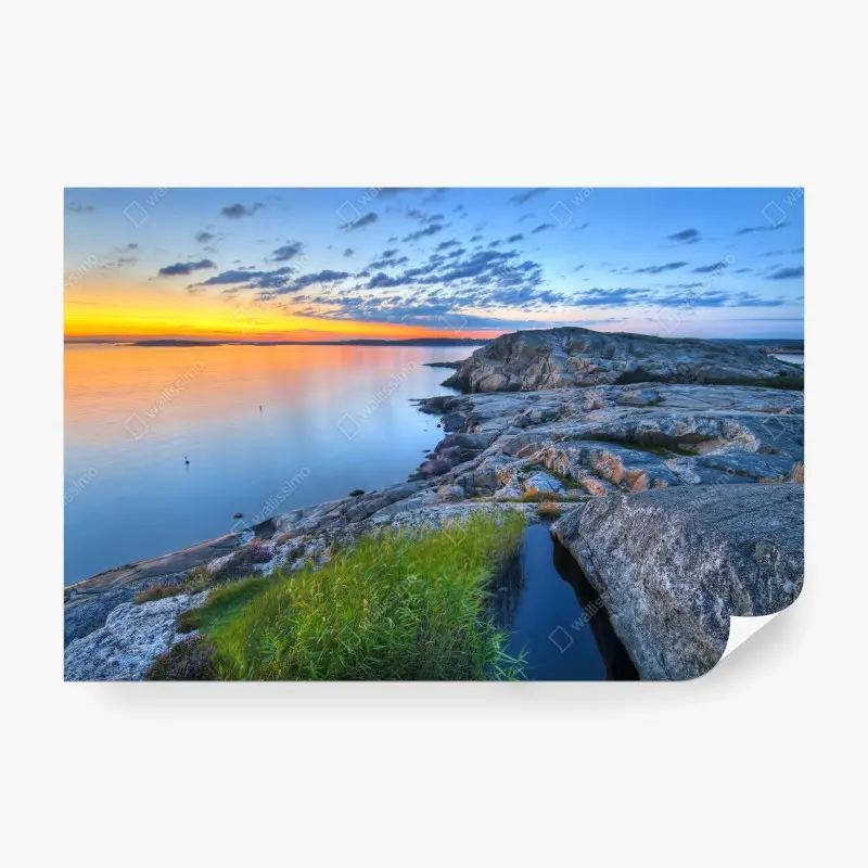 Wall mural tranquil coastal sunset over rocky shore