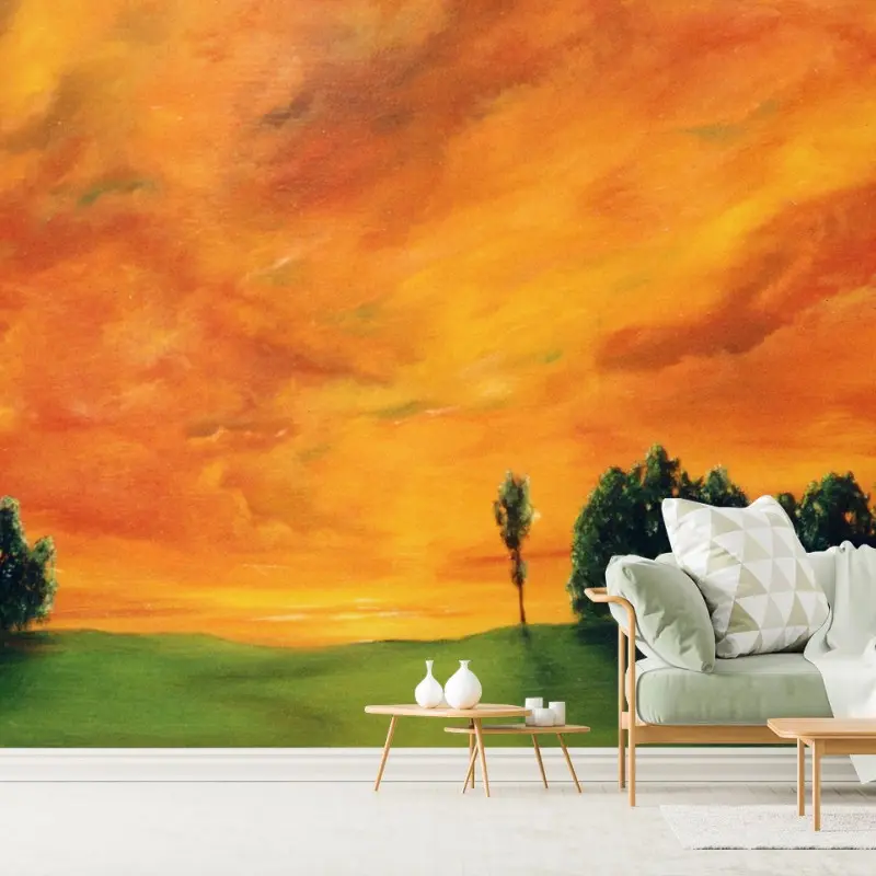 Wall mural fiery sunset over green meadow