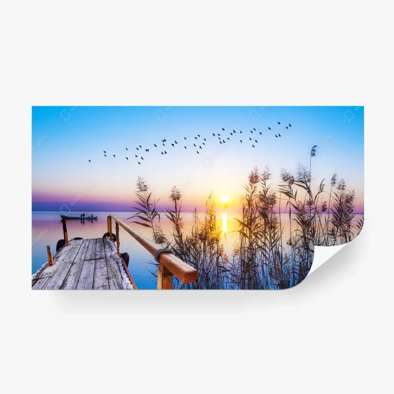 Wall mural serene sunrise over lakeside dock