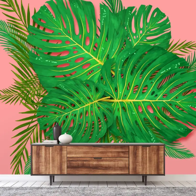 Wall mural vibrant monstera leaves on pink background