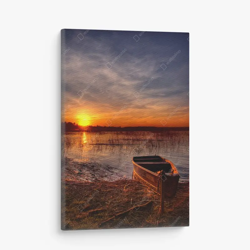 Canvas print sunset boat on a tranquil lake